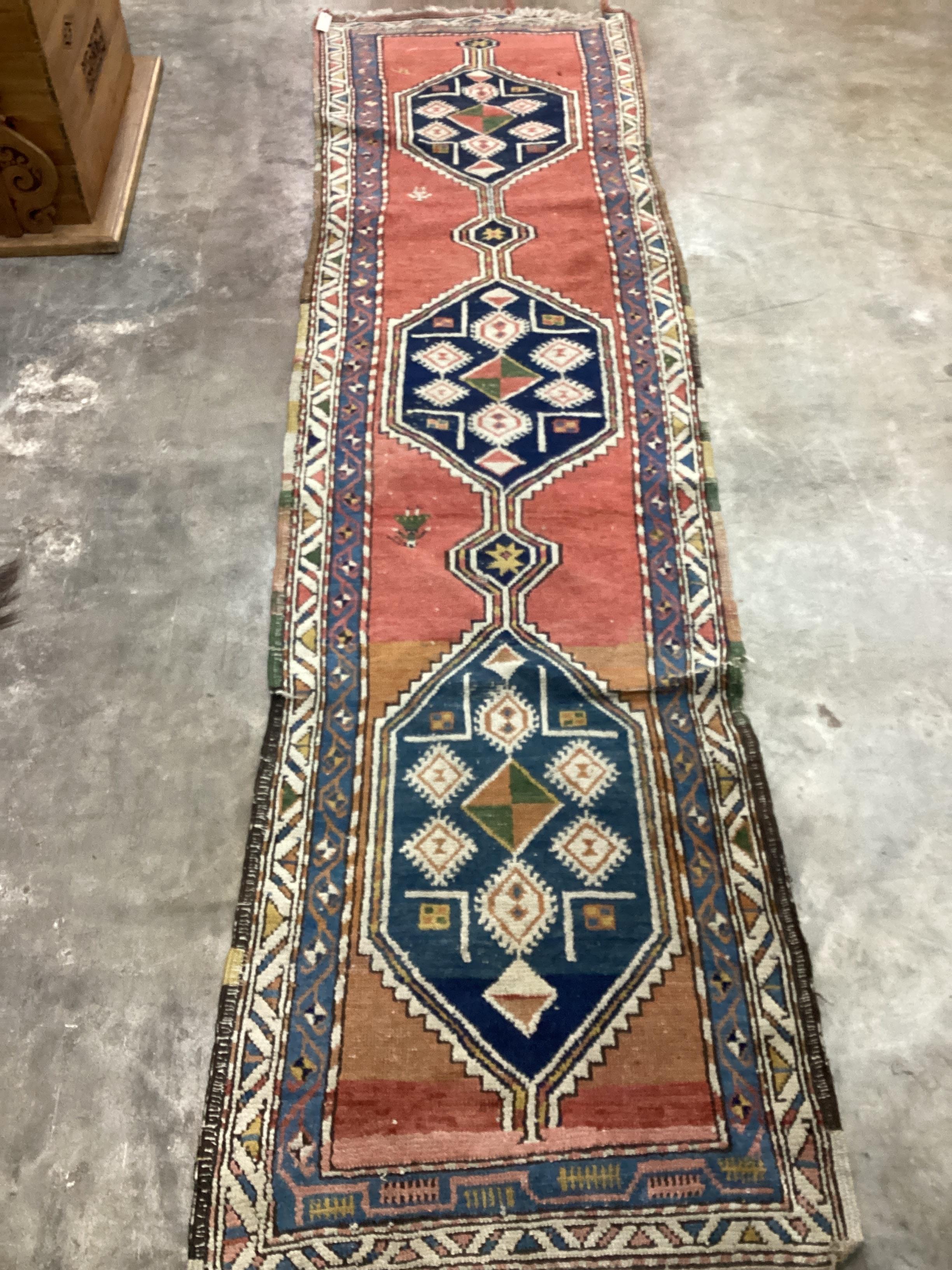 A Turkish red ground runner, 340 x 95cm